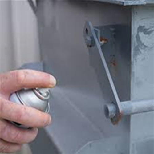 Applying a coating of zinc rich paint to protect this steel cabinet